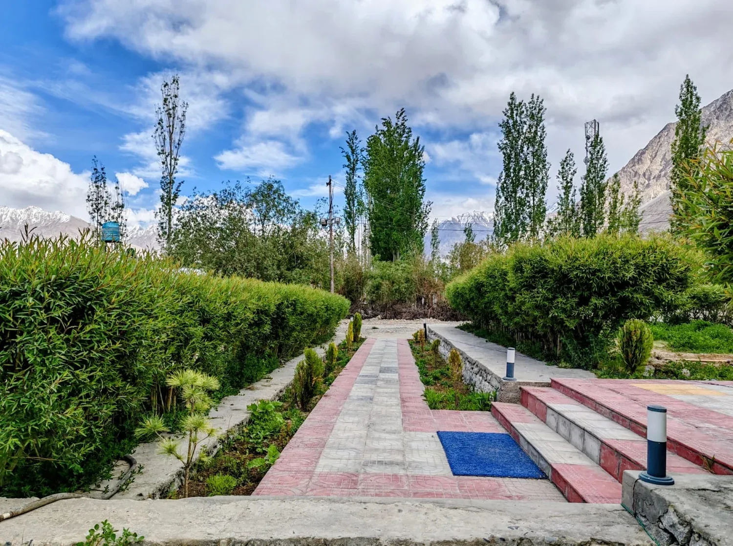 Garden path and mountain surroundings at Maryoul Guest House in Hunder
