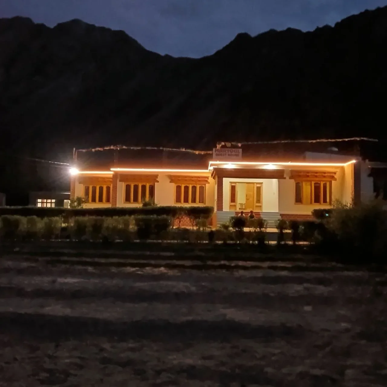 Maryoul Guest House illuminated at night